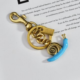 Foto 2 | Foto 2 | Llavero Con Colgante En Forma De Caracol Concha Dorada Y Aleación Azul - Venta Internacional.